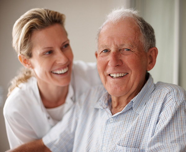 smiling resident and caretaker